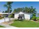 Charming single-story home with well-maintained lawn, surrounded by lush landscaping and trees at 8467 Imperial Cir, Palmetto, FL 34221