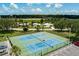 Overhead view of community tennis courts and homes with mature green landscaping at 8467 Imperial Cir, Palmetto, FL 34221