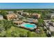 A beautiful aerial view of a community featuring a pool, pool house, and vibrant landscaping at 8827 White Sage Loop, Lakewood Ranch, FL 34202