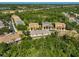 An aerial view shows the layout of the neighborhood with townhomes and lush green trees at 8827 White Sage Loop, Lakewood Ranch, FL 34202