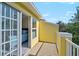 Balcony with white railings, open sliding door, and views of the surrounding trees at 8827 White Sage Loop, Lakewood Ranch, FL 34202
