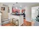 Stylish kitchen featuring a breakfast bar, dark countertops, and stainless steel appliances at 8827 White Sage Loop, Lakewood Ranch, FL 34202