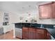 Modern kitchen with sleek granite countertops, stainless steel dishwasher, and warm wood cabinetry at 8827 White Sage Loop, Lakewood Ranch, FL 34202