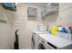 Convenient laundry room with washer, dryer, and wire shelving for storage at 8827 White Sage Loop, Lakewood Ranch, FL 34202