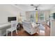 This living room features hardwood floors and sliding doors leading to the balcony at 8827 White Sage Loop, Lakewood Ranch, FL 34202