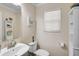 Well-lit bathroom with a modern vanity and storage, toilet and wall mirror at 8827 White Sage Loop, Lakewood Ranch, FL 34202