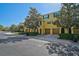 Townhome exterior showing garages, landscaping, and yellow facade at 8827 White Sage Loop, Lakewood Ranch, FL 34202