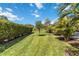 A lush backyard with healthy green grass and mature landscaping, offering serene outdoor space at 9061 Luna Ln, Sarasota, FL 34241