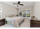 Cozy bedroom with a ceiling fan, large window, and neutral decor at 9061 Luna Ln, Sarasota, FL 34241