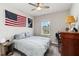 Bedroom featuring a ceiling fan, a large window, and gray color scheme at 9061 Luna Ln, Sarasota, FL 34241