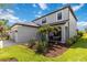 Beautiful home exterior with lush landscaping, gray paint, and a cozy front porch at 9061 Luna Ln, Sarasota, FL 34241