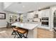 Bright kitchen with white cabinetry, stainless appliances, a large island and stylish bar stools at 9061 Luna Ln, Sarasota, FL 34241