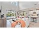 Bright, airy living room with high ceilings, ample seating, seamlessly integrates with kitchen and outdoor pool at 9061 Luna Ln, Sarasota, FL 34241