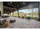 Inviting covered patio area, furnished with plush seating overlooking the serene pool and lush landscape at 9061 Luna Ln, Sarasota, FL 34241