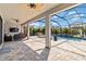 Covered outdoor patio with a pool, fan, and outdoor furniture at 9061 Luna Ln, Sarasota, FL 34241