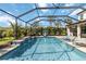 Relax in your screened-in pool with a waterfall feature and comfortable poolside seating at 9061 Luna Ln, Sarasota, FL 34241
