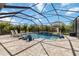 Screened-in pool with stone decking, lounge chairs, and a basketball hoop for outdoor fun at 9061 Luna Ln, Sarasota, FL 34241