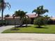 Well-maintained single-story home featuring a red tile roof, lush landscaping, and a spacious two-car garage at 3724 71St E Ter, Sarasota, FL 34243