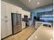 Modern kitchen featuring stainless steel appliances, white cabinets, and a spacious island with countertop seating at 3724 71St E Ter, Sarasota, FL 34243