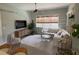 Bright living area with neutral tones, large window and comfortable sectional sofa at 3724 71St E Ter, Sarasota, FL 34243