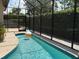 A screened-in pool area with a pebble-finished deck and privacy hedges, perfect for relaxing at 3724 71St E Ter, Sarasota, FL 34243