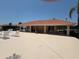 Pool house with covered seating areas and multiple lounge chairs, perfect for relaxation at 3724 71St E Ter, Sarasota, FL 34243