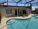 A backyard pool and patio with string lights and a covered seating area, ideal for outdoor entertaining at 3724 71St E Ter, Sarasota, FL 34243