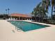 Outdoor swimming pool with metal ladders and clear water, surrounded by a concrete deck and lounge chairs at 3724 71St E Ter, Sarasota, FL 34243