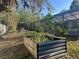 This backyard offers a screened-in patio, gardening space, and room for other backyard activities at 1010 Gun Club Rd, Sarasota, FL 34232