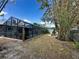 This backyard features a screened-in pool, patio with room for outdoor dining, and well-placed landscaping at 1010 Gun Club Rd, Sarasota, FL 34232