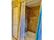 This bathroom features a tub with a shower and decorative brown-tone tiling at 1010 Gun Club Rd, Sarasota, FL 34232