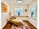 Cozy bedroom featuring natural light, hardwood floors, and a chaise lounge at 1010 Gun Club Rd, Sarasota, FL 34232