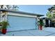 Spacious two car garage with stone details and mature landscaping at 1010 Gun Club Rd, Sarasota, FL 34232