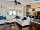 Comfortable living space featuring hardwood floors and opening into a kitchen with a breakfast bar at 1010 Gun Club Rd, Sarasota, FL 34232