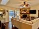 Living room features a stone fireplace, ceiling fan and sliding glass door to the outside at 1010 Gun Club Rd, Sarasota, FL 34232