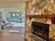 Living room highlighting the fireplace and pool view beyond sliding glass doors at 1010 Gun Club Rd, Sarasota, FL 34232