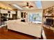 Bright living room featuring hardwood floors, stone fireplace, and sliding glass doors to the pool at 1010 Gun Club Rd, Sarasota, FL 34232