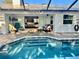 Inviting screened pool and patio area extends from the interior with a comfortable seating area at 1010 Gun Club Rd, Sarasota, FL 34232