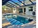Relaxing screened pool area features ample deck space and a clear view of the back yard at 1010 Gun Club Rd, Sarasota, FL 34232