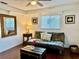 Sitting room with hardwood floors, futon, and bright natural light at 1010 Gun Club Rd, Sarasota, FL 34232