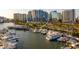 Aerial view of waterfront condominium building surrounded by boats and city skyline at 1155 N Gulfstream Ave # 706, Sarasota, FL 34236