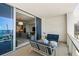 Inviting balcony with comfortable seating and a partial view of the living room and kitchen at 1155 N Gulfstream Ave # 706, Sarasota, FL 34236