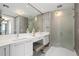 Elegant bathroom featuring a double vanity, large mirror, glass shower, and modern fixtures, creating a spa-like experience at 1155 N Gulfstream Ave # 706, Sarasota, FL 34236