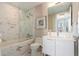 Modern bathroom features marble walls, glass shower door, and white vanity at 1155 N Gulfstream Ave # 706, Sarasota, FL 34236