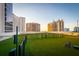 Pet-friendly dog park with green space, fencing, and playful dog, offering a safe and enjoyable area for pets at 1155 N Gulfstream Ave # 706, Sarasota, FL 34236