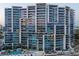Modern, high-rise condominium building with sleek architectural design, multiple balconies, and views of the city and waterfront at 1155 N Gulfstream Ave # 706, Sarasota, FL 34236