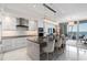 Modern kitchen features a breakfast bar, stainless steel appliances, and an open layout to the living area with water view at 1155 N Gulfstream Ave # 706, Sarasota, FL 34236