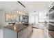Modern kitchen features a center island, stainless steel appliances, and an open layout to the dining area at 1155 N Gulfstream Ave # 706, Sarasota, FL 34236