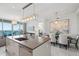 Bright kitchen with modern island features a beautiful water view and a dining area with stunning decor at 1155 N Gulfstream Ave # 706, Sarasota, FL 34236