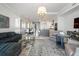 Open-concept living room with elegant furniture, showcasing dining and kitchen areas with plenty of space for entertaining at 1155 N Gulfstream Ave # 706, Sarasota, FL 34236